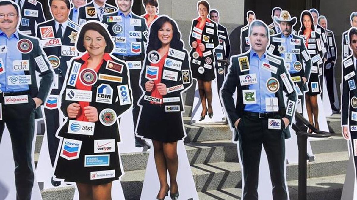 Cutouts of legislators with images of their top donors on the steps of the California Capitol in Sacramento on Aug. 26, 2015.