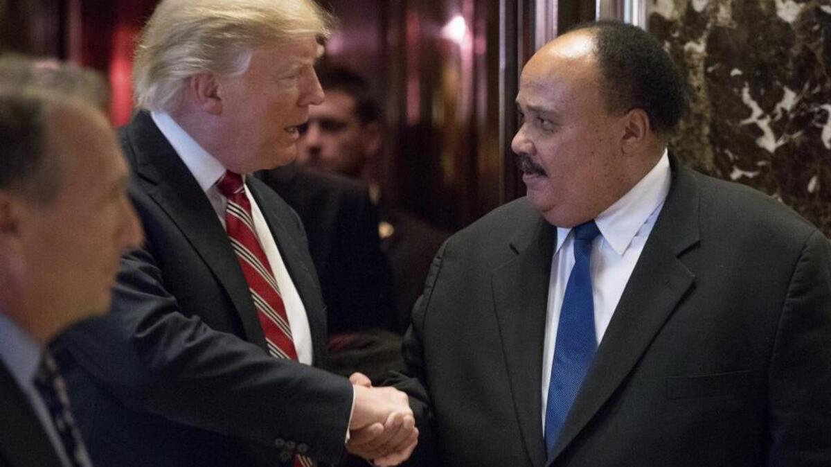President-elect Donald Trump shakes hands with Martin Luther King III, son of Martin Luther King Jr. at Trump Tower in New York. King III, met with Trump on the King holiday in 2017, four days before Trump took office.