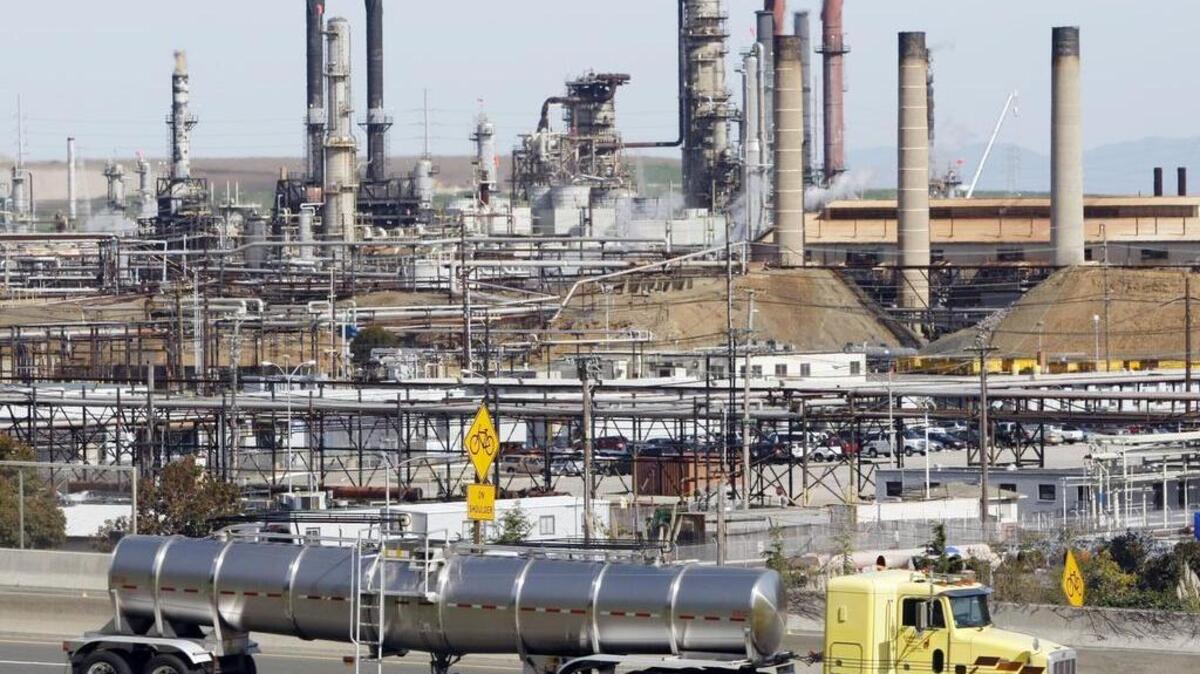 
This March 9, 2010 file photo shows a tanker truck passing the Chevron oil refinery in Richmond, Calif.
