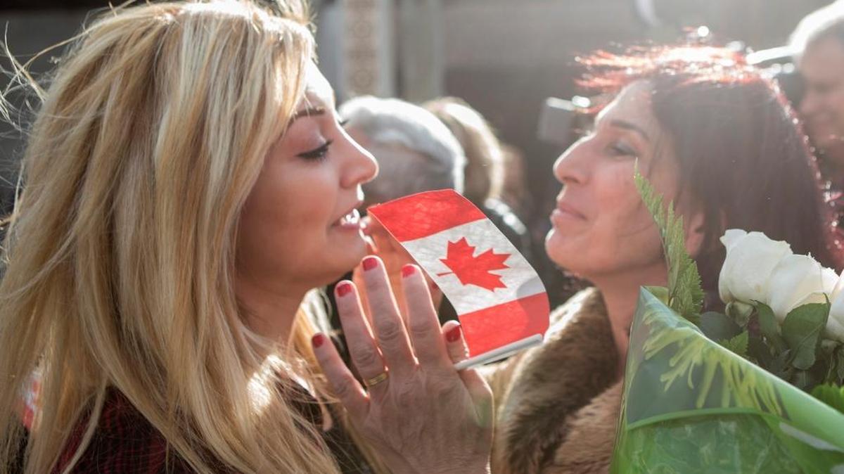 Maria Karageozian, left, greets her mother Elo Manushian, a refugee from Syria, as others arrive at the Armenian Community Centre in Toronto last week.