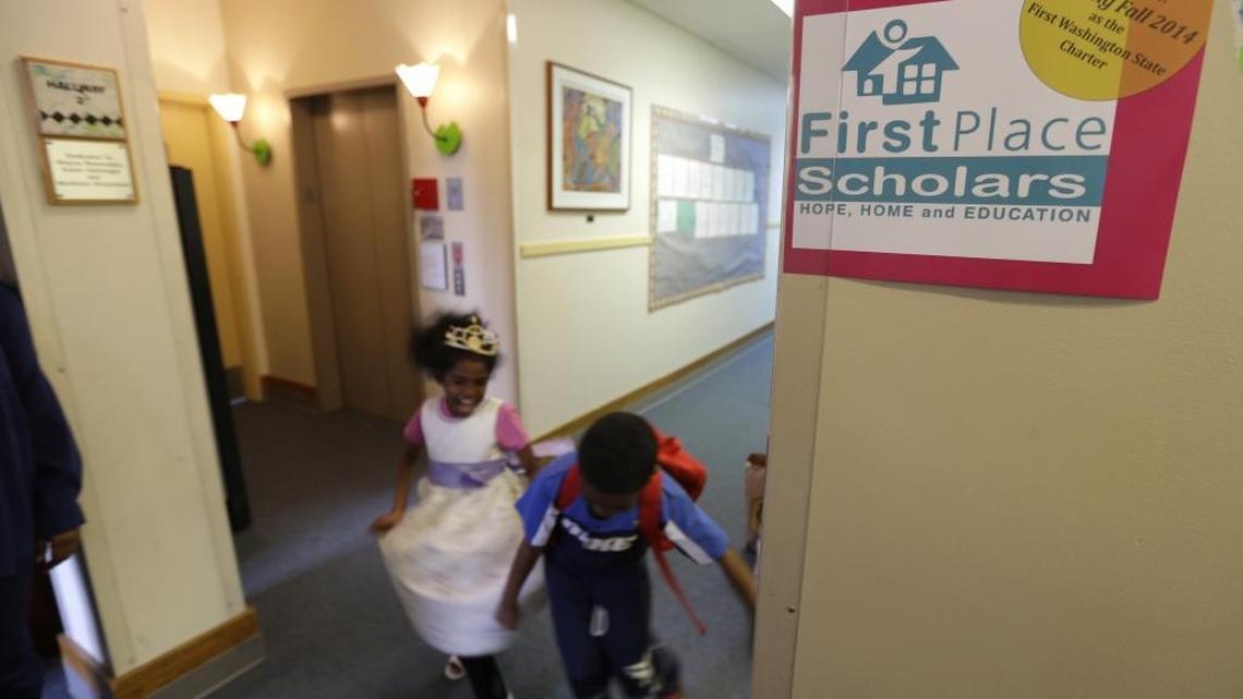 In this June 18, 2014 file photo, twins Deborah, left, and Petros Kahssay, 8, walk through a hallway at First Place Scholars Charter School, Washington’s first charter school, in Seattle.