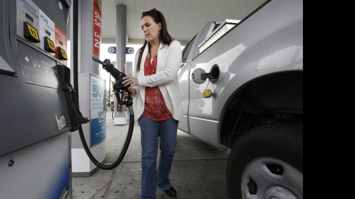 
Lydia Holland replaces the gas nozzle after filling up at a Sacramento gas station in 2014. The Tax Foundation says in a new report that California’s gas tax, which recently dropped by 6 cents a gallon, is now the nation’s fourth highest. 
