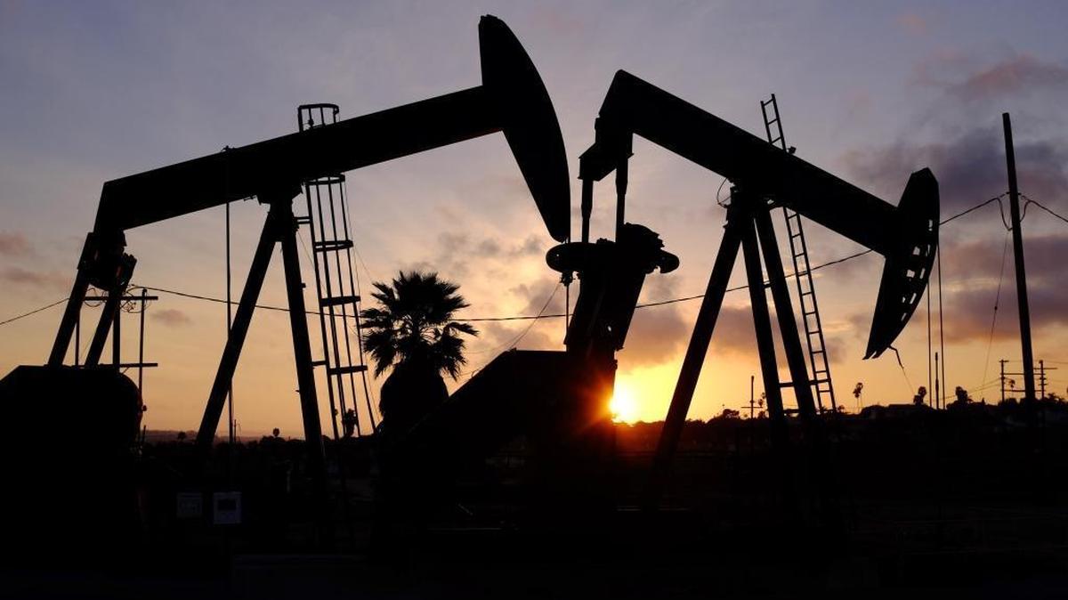 This Thursday March 6, 2014 photo shows the setting sun behind pumpjacks operating at the Inglewood oil fields in the Baldwin Hills area of Los Angeles.
