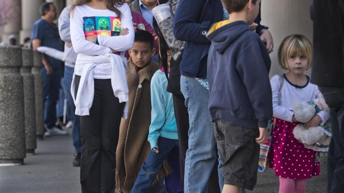 People wait in line in 2014 at Kaiser Permanente during a a community flu vaccine clinic. The Kaiser Health Plan Foundation has had an active role in crafting a bill on tax swaps for health plans. The legislation awaits a vote by state lawmakers.