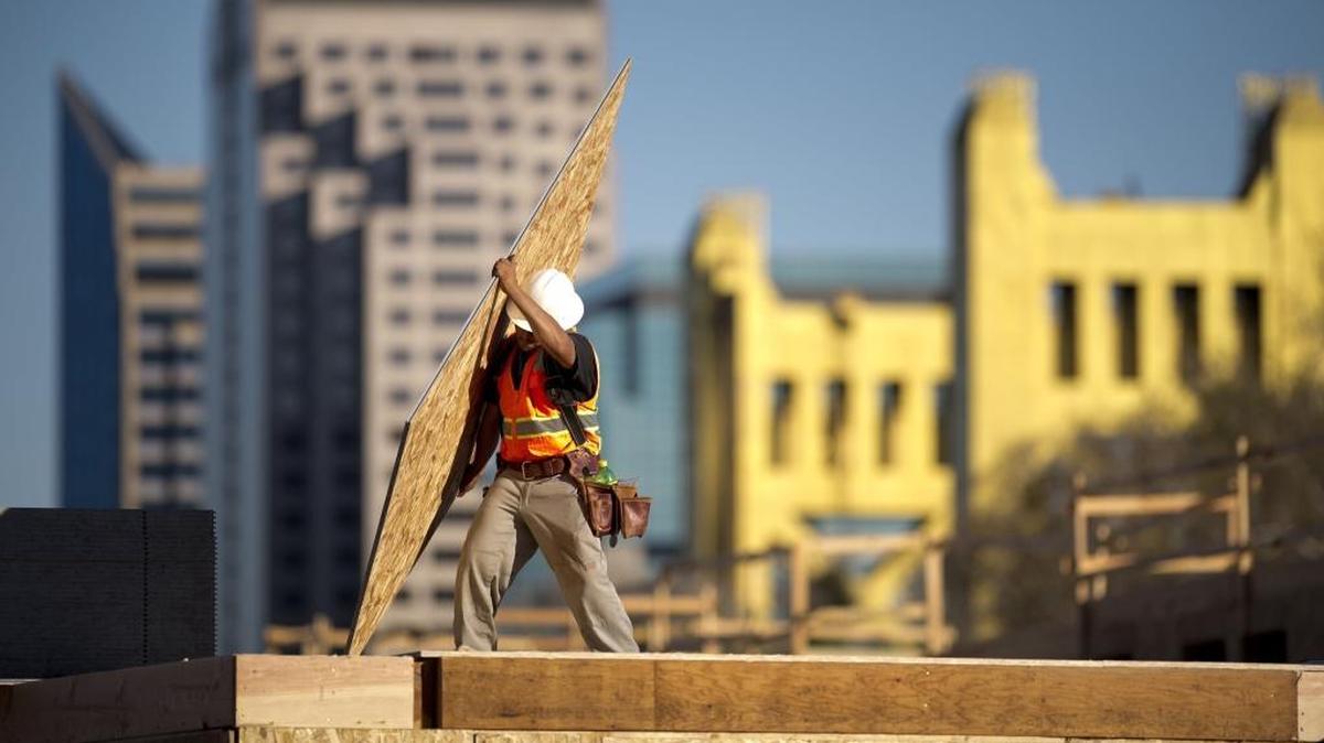 Construction workers finish off the roof on the northwest corner of the Capitol Yards Apartments in West Sacramento on Feb. 24, 2014. Construction is one of the state’s most injury-prone jobs.
