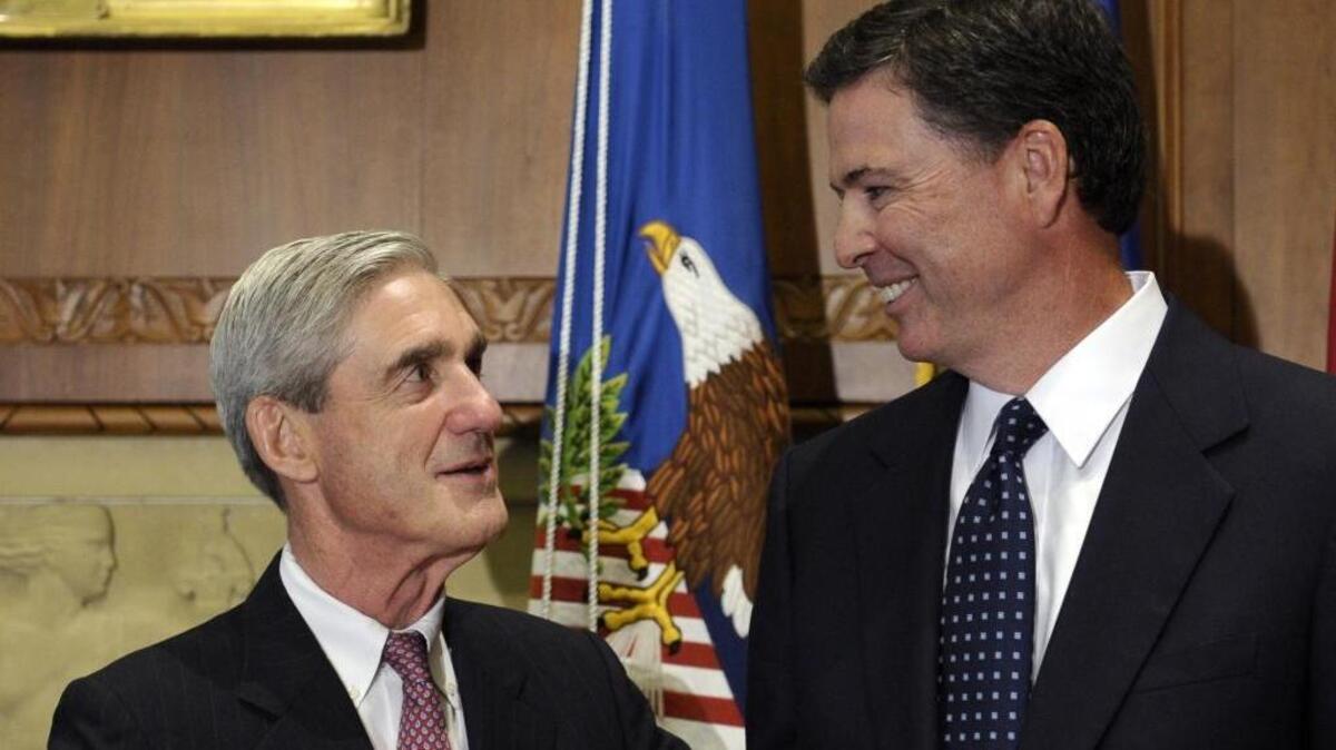 In this Sept. 4, 2013, file photo, then-incoming FBI Director James Comey talks with outgoing FBI Director Robert Mueller.