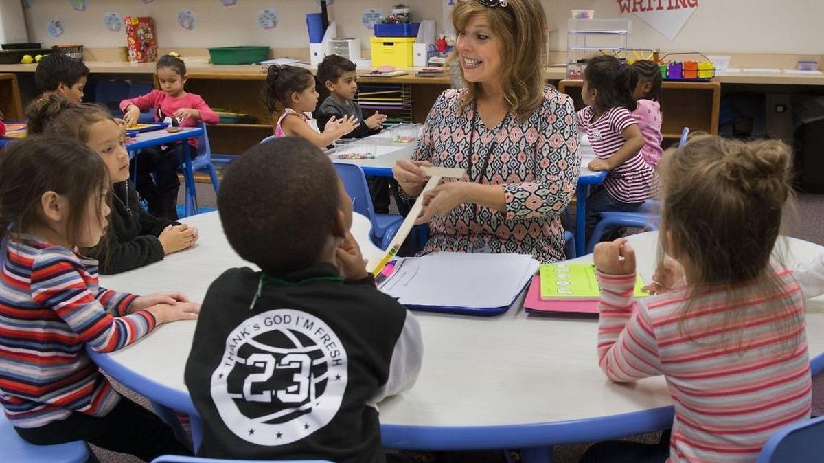Teacher’s aide Heidi Ochoa teaches preschool students at Natomas Park Elementary School in Sacramento on Oct. 4, 2016.