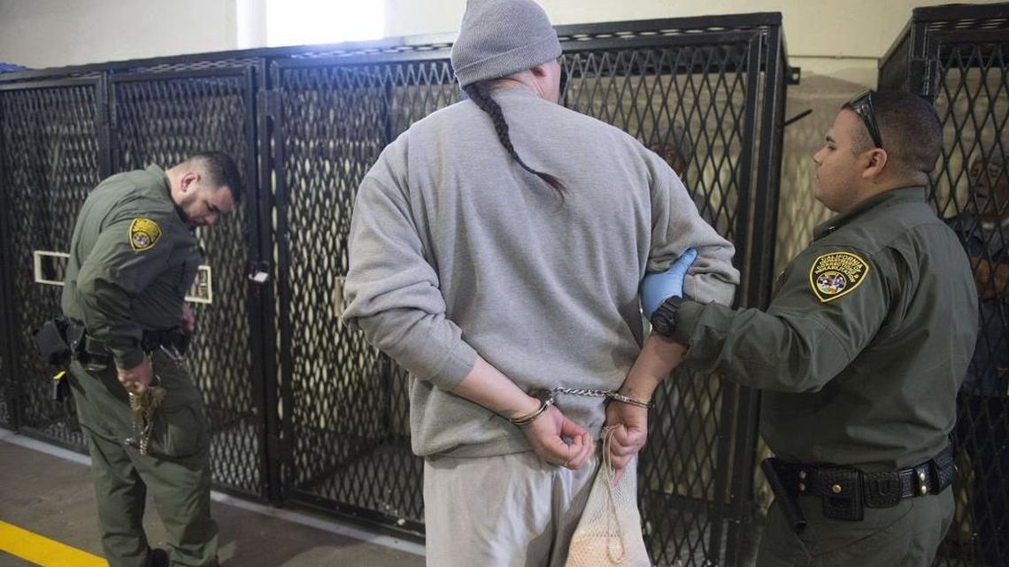 A condemned inmate is moved by corrections officers inside East Block at San Quentin State Prison on Tuesday, December. 29, 2015, in San Quentin.