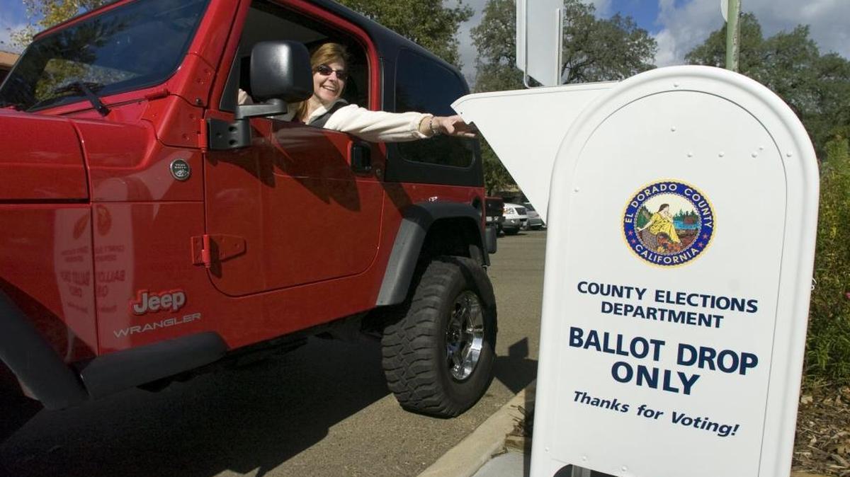 An El Dorado County voter in 2008 drops off her mail ballot. State senators gave final approval Monday to legislation that would phase in neighborhood vote centers and other changes as a way to increase voter participation.