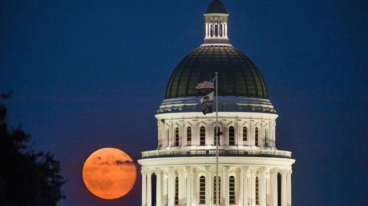
The full moon rises over the state Capitol in Sacramento on Friday, July 31, 2015. 
