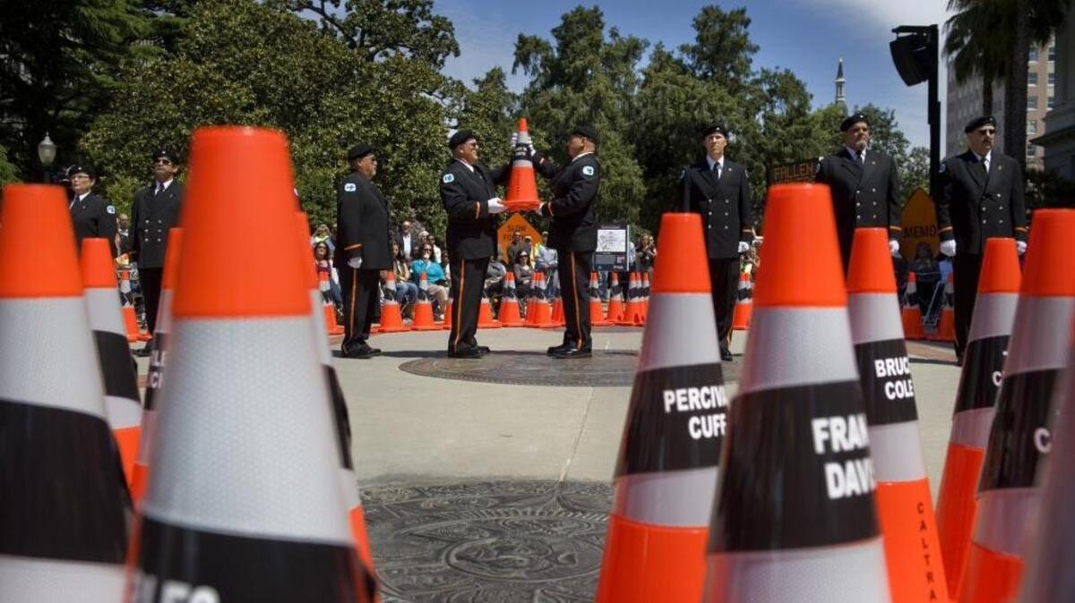 CalTrans Honor Guard members pass a cone bearing the name of fallen worker during a 2011 ceremony at the California State Capital to memorialize employees killed in the line of duty.