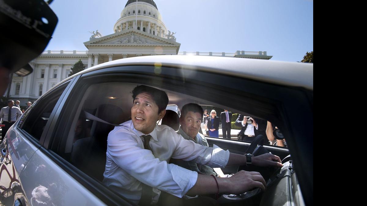
California Senate President Pro Tem Kevin de Leon (D) Los Angeles, left, and Jose Mendoza prepare to drive away in a Toyota Prius on the west steps of the state Capitol in Sacramento on Wednesday, May 27, 2015.
