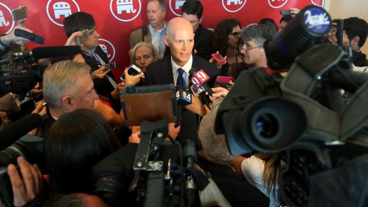 Florida Gov. Rick Scott speaks to the media after a Republican National Committee gathering at Diplomat Hotel in Hollywood, Fla., Thursday, April 21, 2016.