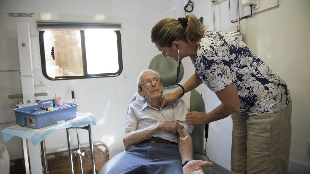 Dr. Celia Sutton-Pado examines Leland Pauly, 90, who has lived in Camptonville his whole life, on Sept. 1, 2015. On the first Tuesday of every month, the Western Sierra Medical group sends a mobile health clinic to the community resource center in Camptonville. The shortage of rural health care providers has worsened as more and more people enroll in the Affordable Care Act.