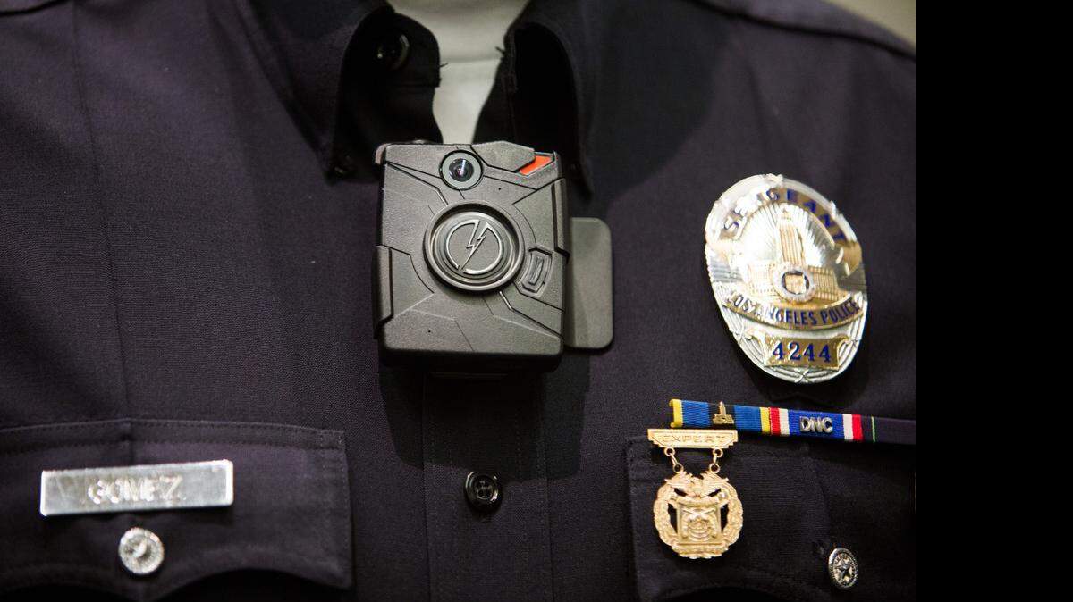 
A Los Angeles police officer in December shows an on-body camera last year. California Attorney General Kamala Harris said Friday that the Department of Justice will become the first statewide agency to outfit its agents with body cameras.
