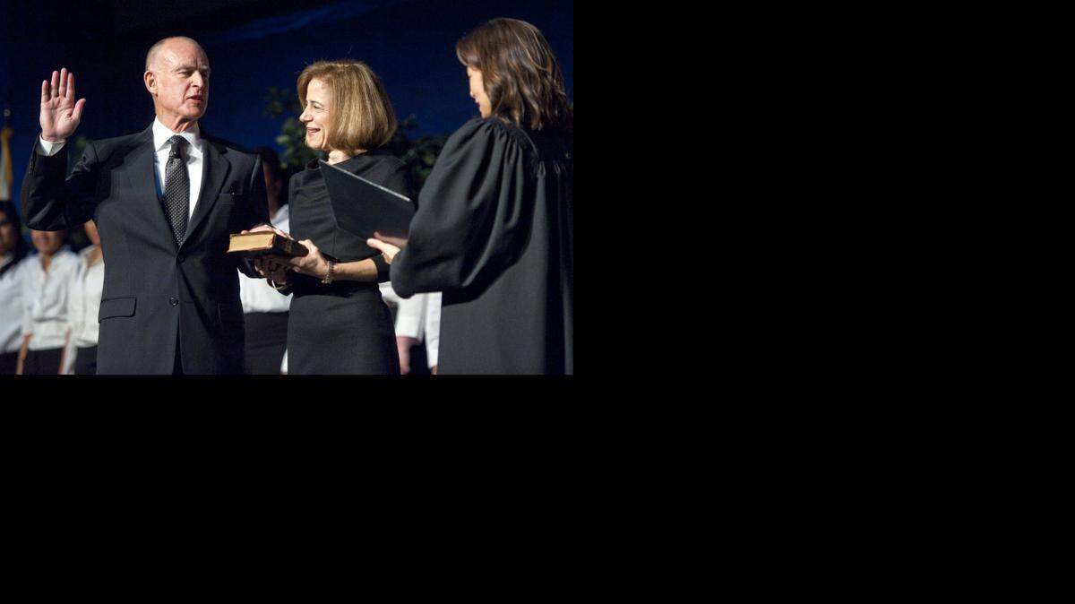 
Gov. Jerry Brown is sworn in by Chief Justice of the state Supreme Court Tani Cantil-Sakauye, while his wife Anne Gust Brown holds a Bible on Monday, January 3, 2011 at the Memorial Auditorium in Sacramento.
