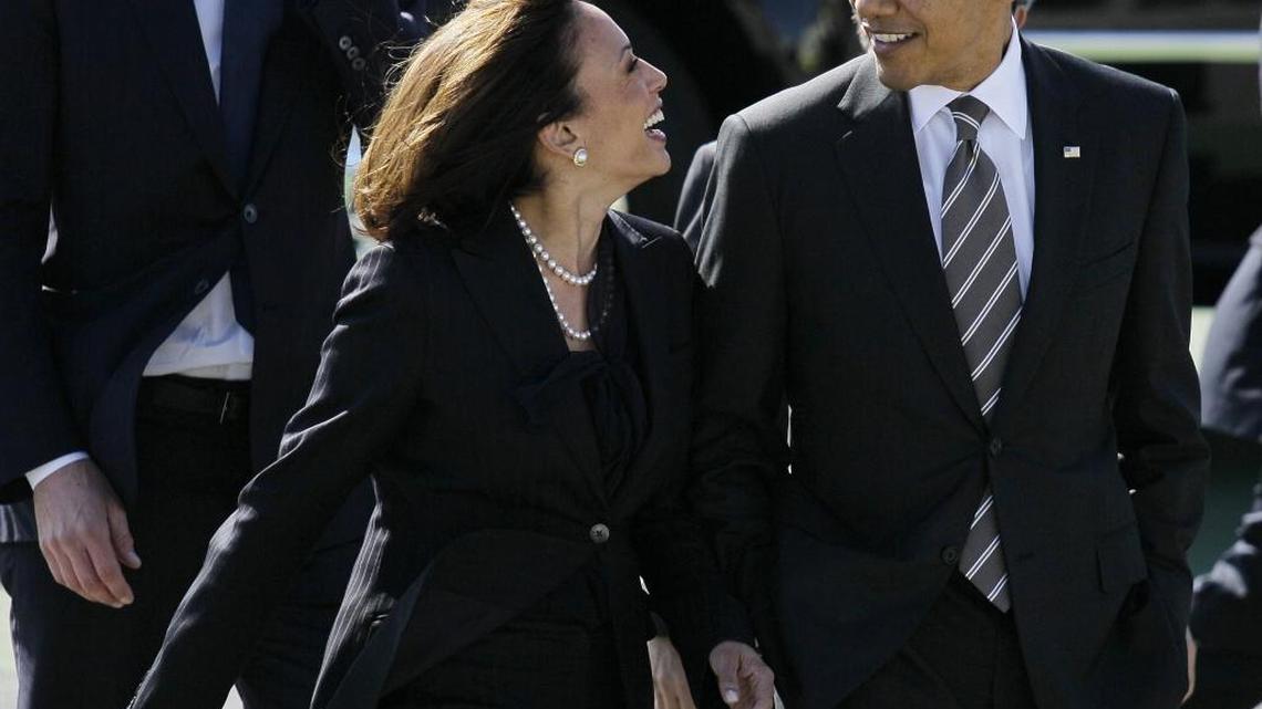 President Barack Obama walks with California Attorney General Kamala Harris after arriving at San Francisco International Airport in San Francisco in 2012.