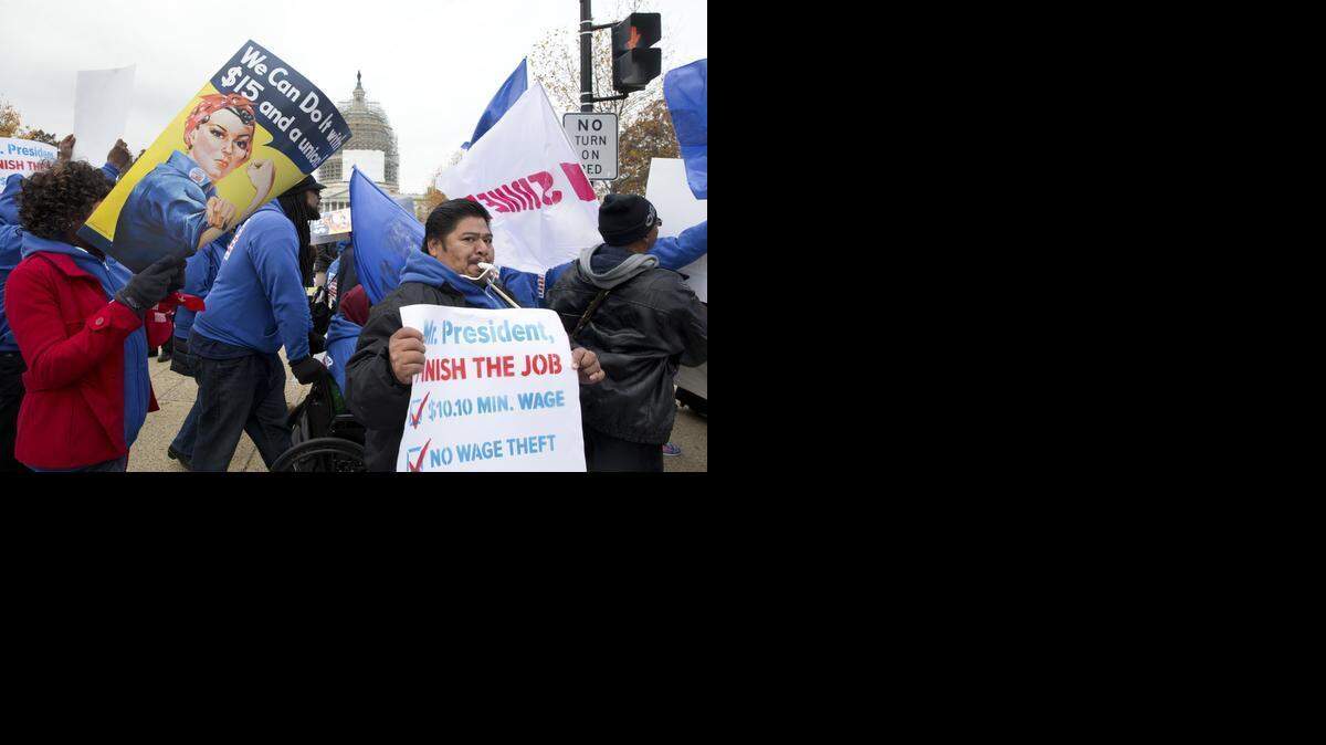 
FILE -- Demonstrators protest for an increase in the minimum wage outside the Capitol Building in Washington on Nov. 13, 2014. A new study shows that income inequality sharply increased in California as the state emerged from the Great Recession.
