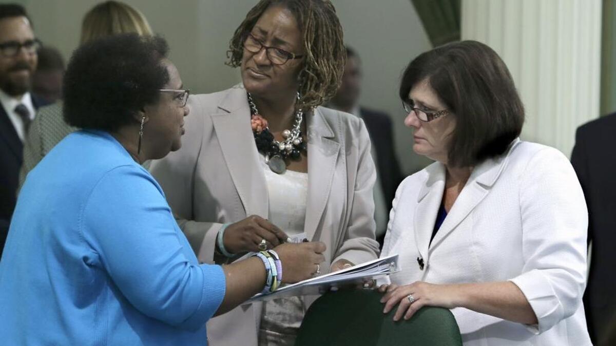 Assemblywoman Shirley Weber, D-San Diego, left, discusses legislation with Sen. Holly Mitchell, D-Los Angeles, center, and Assemblywoman Susan Bonilla, D-Concord, at the Capitol, Wednesday, Sept. 2, 2015. AP Photo/Rich Pedroncelli)