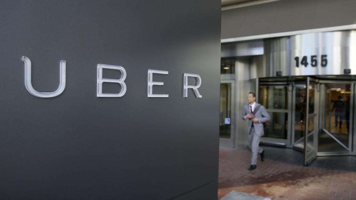 
In this photo taken Dec. 16, 2014, a man leaves the headquarters of Uber in San Francisco. 
