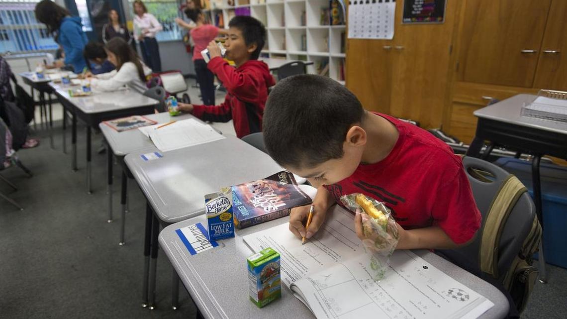 
Hovhannes Muradyan 10, eats breakfast while doing his school work at his desk at White Rock Elementary School in Rancho Cordova in March. Lawmakers on Tuesday announced a new bill to ease a cap on local district budget reserves.
