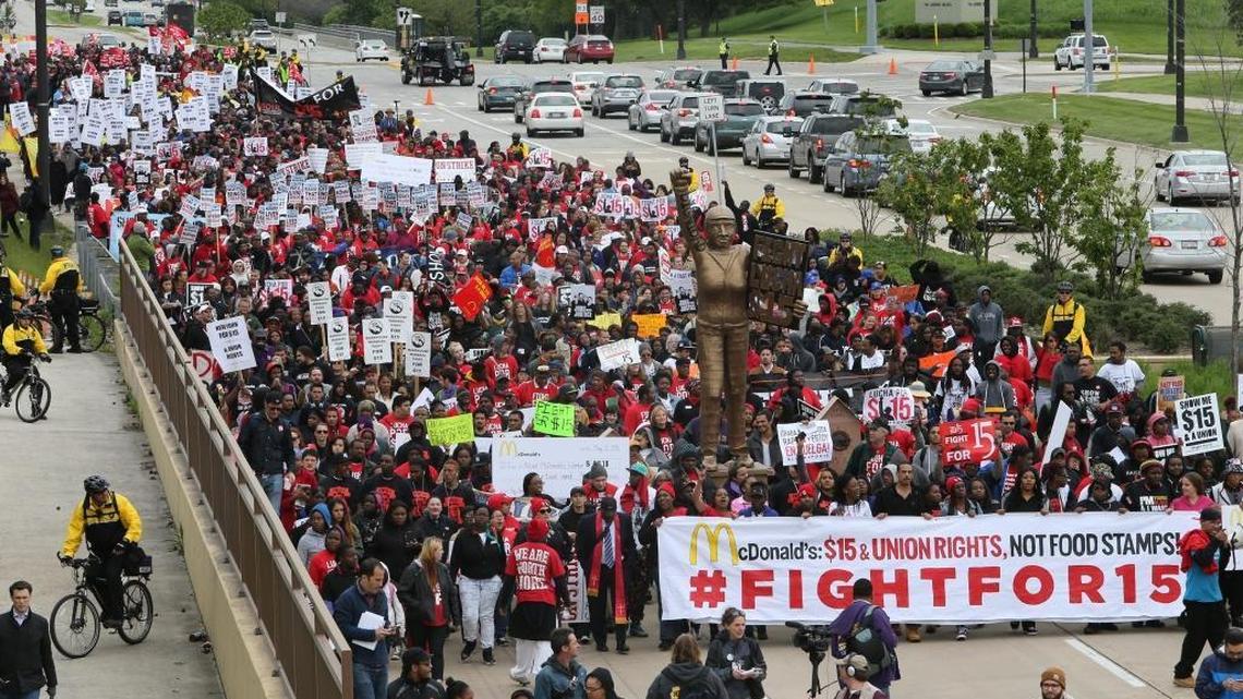 Activists and workers converge near the McDonald's campus during a SEIU-backed Fight for $15 rally on May 20, 2015 in Oakbrook, Ill. The fight is now coming to California.