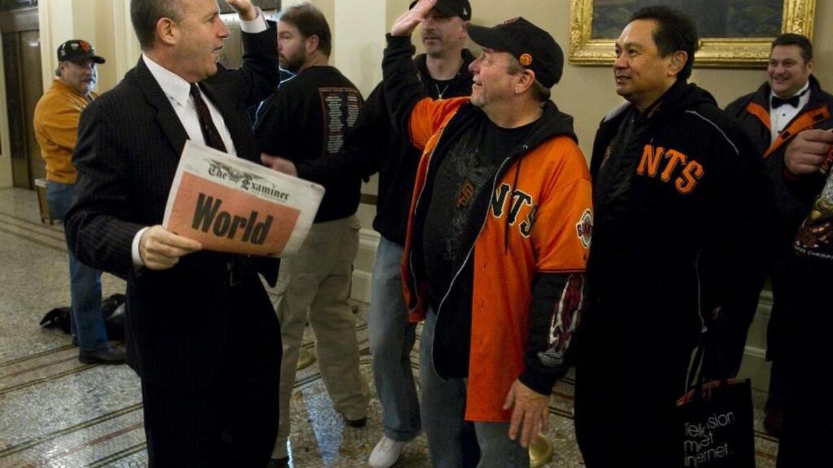 Then-Senate President Pro Tem Darrell Steinberg, D-Sacramento, high-fives a San Francisco Giants fan there to see the World Series trophy at the Capitol on January 6, 2011.