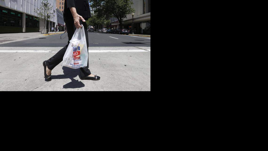 
A woman walks with a plastic bag in Sacramento last May. Opponents of California’s first-in-the-nation statewide ban on plastic bags have qualified a referendum on the law.
