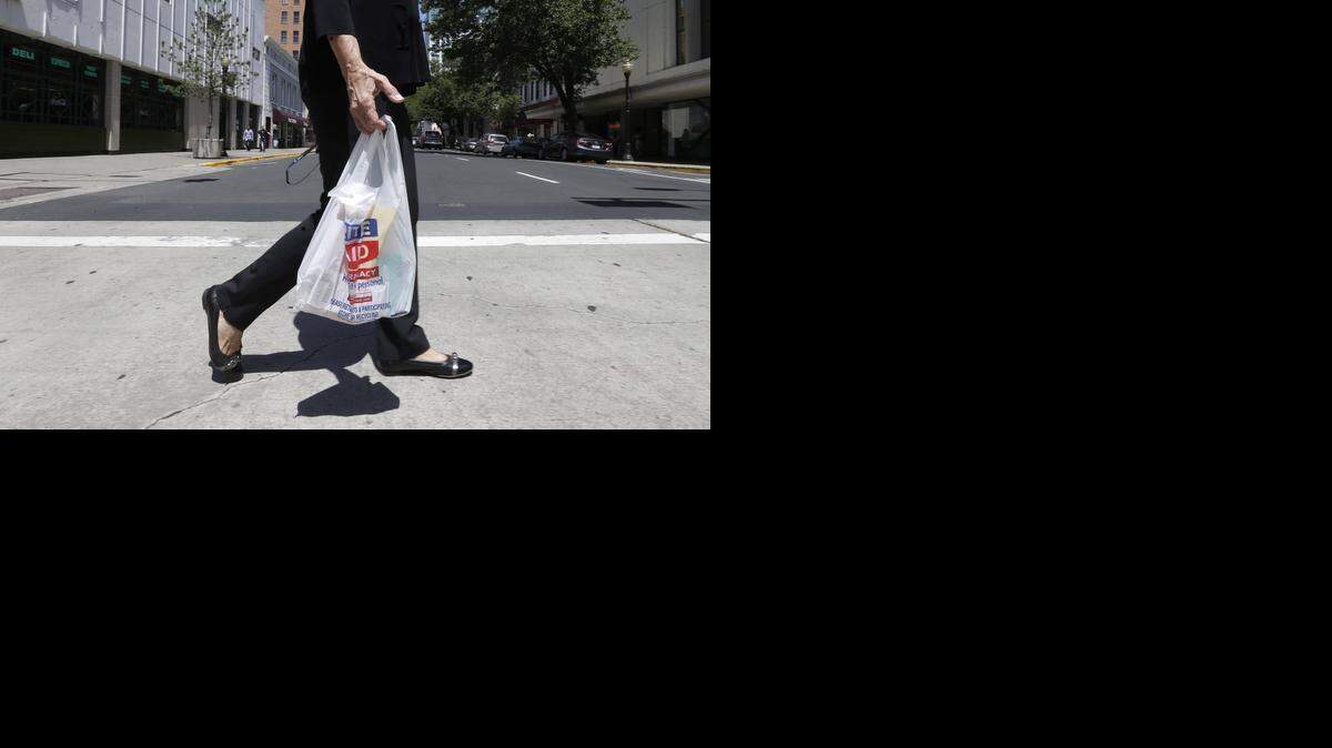 
A woman walks with a plastic bag in Sacramento last May. Opponents of California’s first-in-the-nation statewide ban on plastic bags have qualified a referendum on the law.
