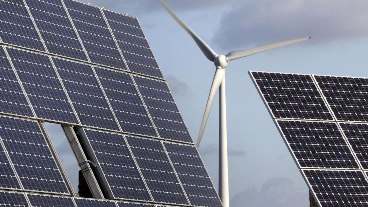 Photovoltaic modules and a windmill in the village of Feldheim near Berlin, Germany, on Nov. 30, 2011. Several California lawmaker attented a sponsored trip to Germany and the Czech Republic last year to learn about renewable energy.