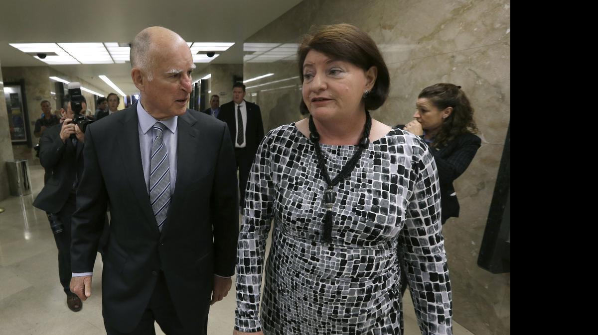 
Gov. Jerry Brown and Assembly Speaker Toni Atkins walk together in March. Brown was noncommittal about a state earned-income tax credit proposed Tuesday by Atkins.
