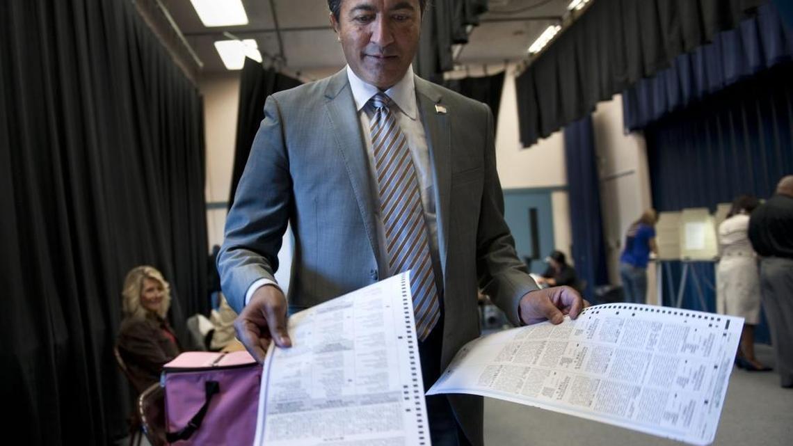 Ami Bera runs his ballot through the scanner while voting in the race in which he outsed former GOP Rep. Dan Lungren in 2012. Now, Bera, who represents a swing district in Sacramento County, is fighting for his own party’s endorsement.