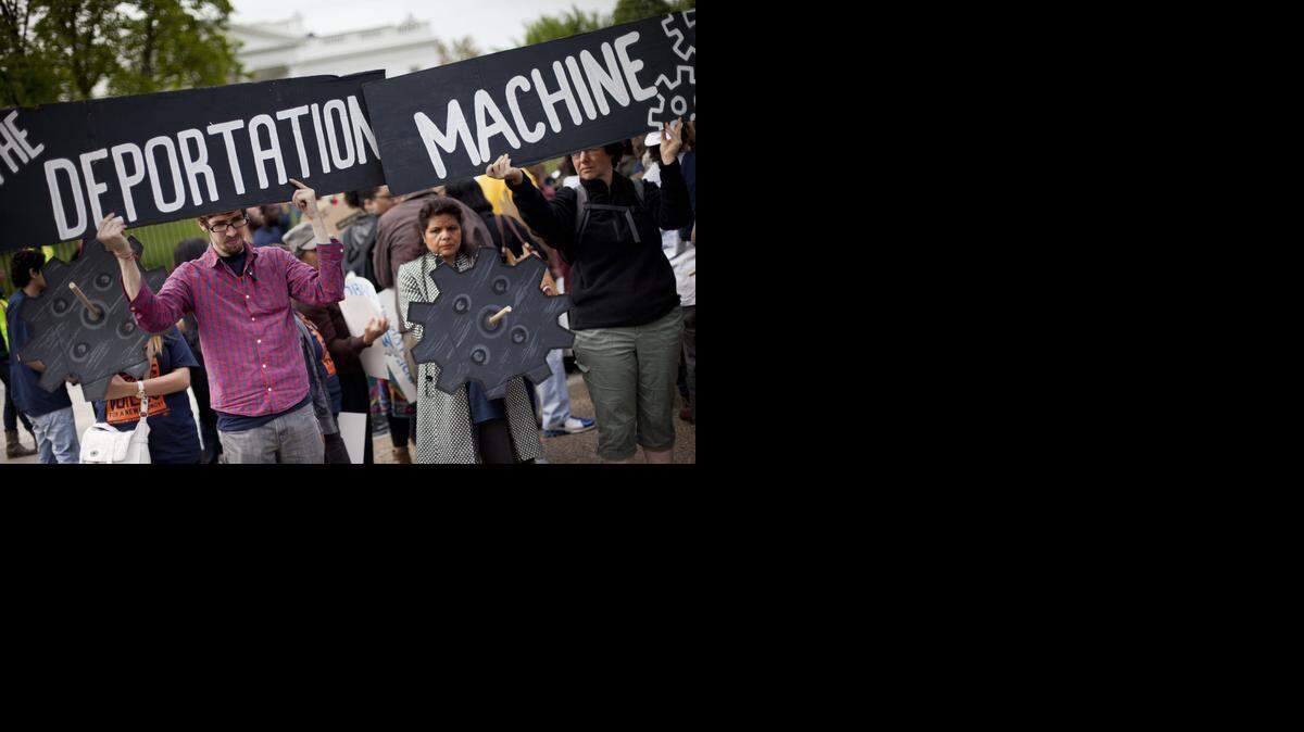 
Demonstrators hold up signs outside the White House in April to demand President Barack Obama stop deportation of undocumented immigrants. California law now prohibits local law enforcement from honoring federal requests to hold undocumented immigrants who are low-level offenders.
