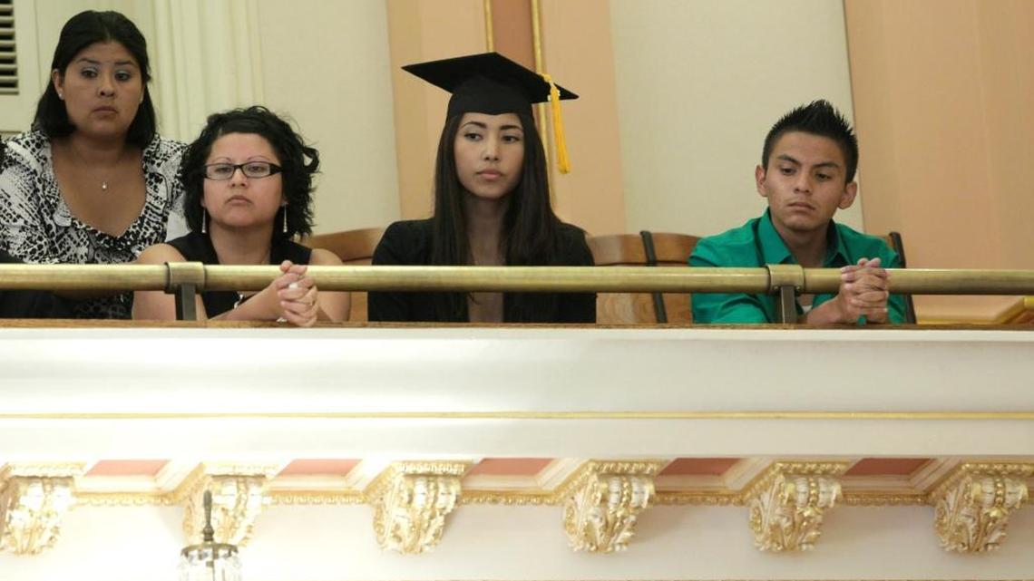 Maria Luna, a 2010 graduate of California State University, Sacramento, sits in the Senate gallery wearing her graduation cap and gown to show her support for a measure to allow students who are in the country illegally, to collect privately funded college scholarships, at the Capitol in Sacramento, Calif., Thursday, July 14, 2011.