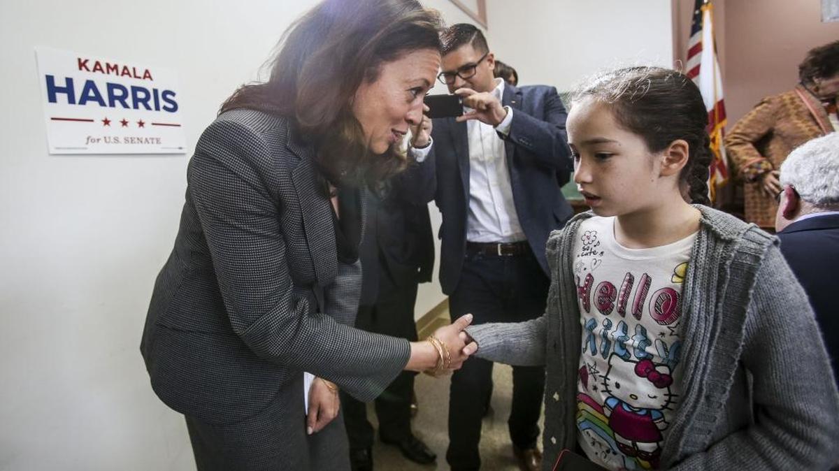Kamala Harris, left, greets Stephanie Reyes, 10, as she arrives for a meet and greet with the U.S. Senate candidate on Sunday.