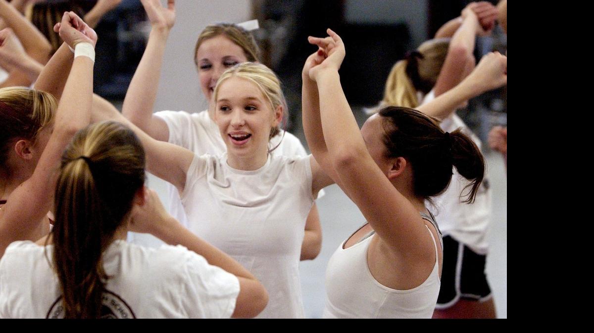 
File photo: Emily Jacobsen (center), 17, practices a routine with fellow members of the Woodcreek High School competitive cheer squad, March 15, 2004.
