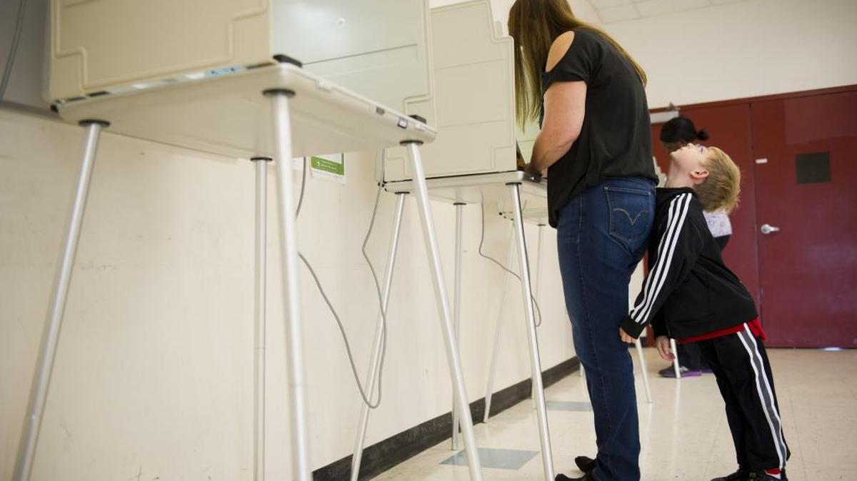 A voter casts her ballot in November 2014 in Sacramento. Gov. Jerry Brown signed a bill Thursday that will allow Sacramento and other counties to decide to consolidate polling places into vote centers in 2018.