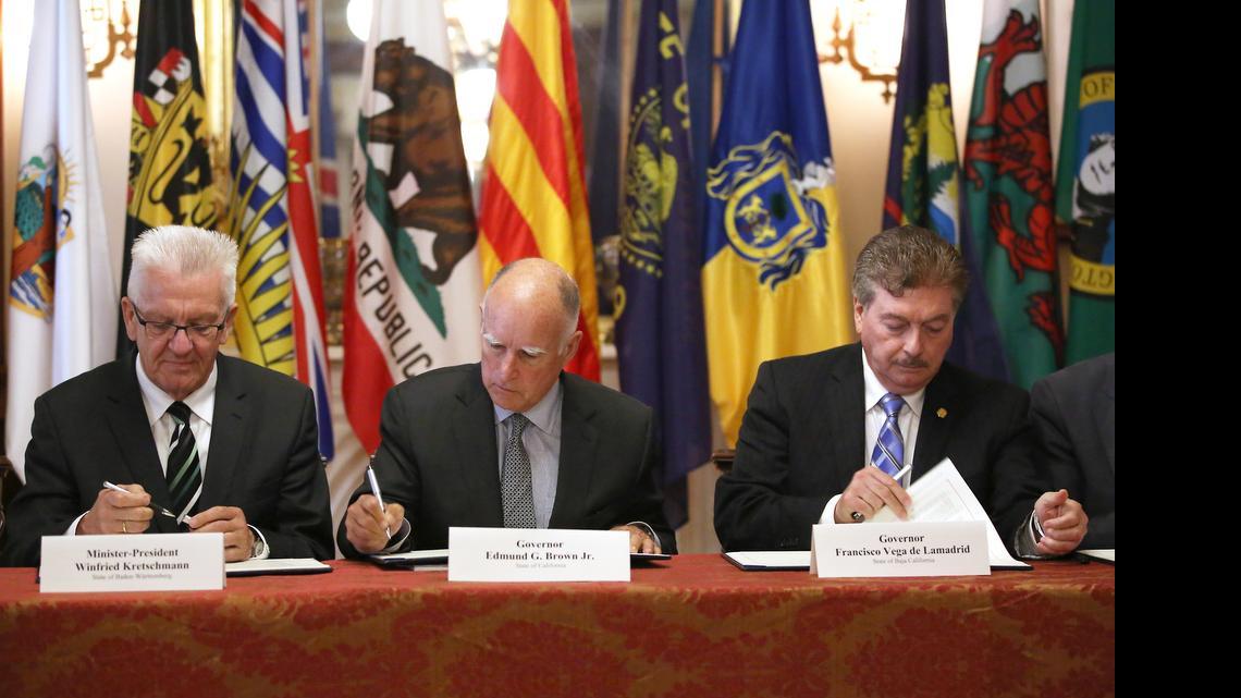 
Gov. Jerry Brown, center, flanked by Baden-Wurttemberg Minister-President Winfried Kretschmann, left, of Germany, and Baja California Gov. Francisco A. Vega de Lamadrid, join others in signing a non-binding climate change agreement in Sacramento, Calif., Tuesday, May 19, 2015. The memorandum of understanding calls for limiting the increase of global warming average to below 2 degrees Celsius.
