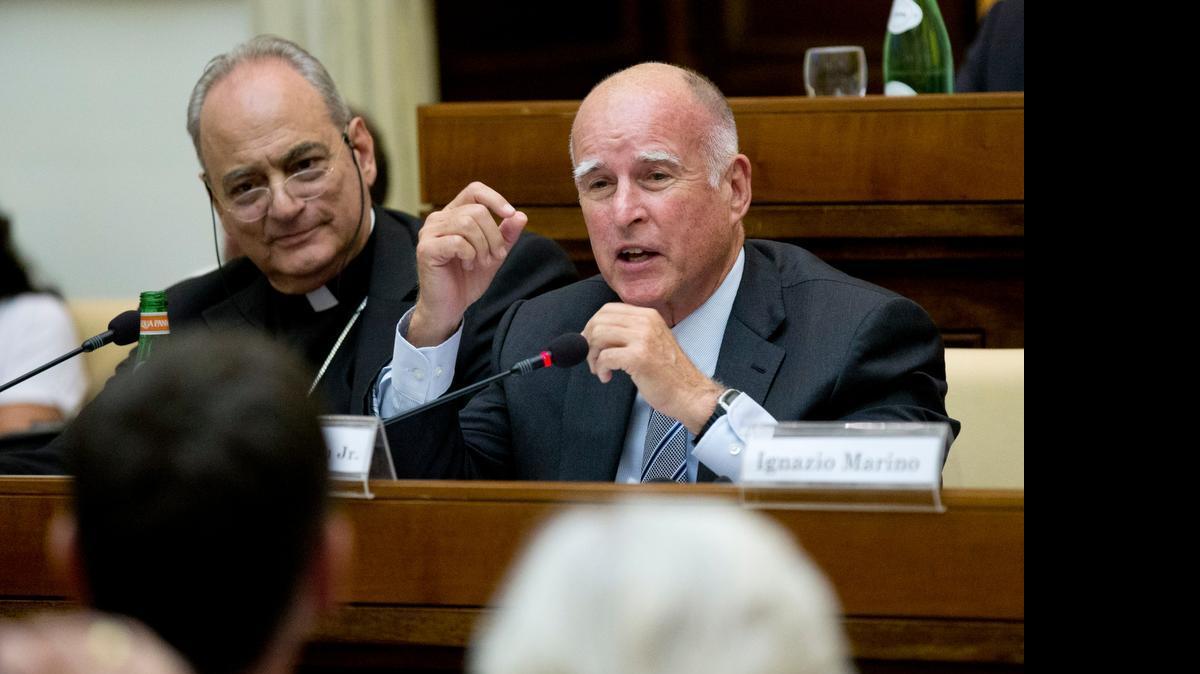 
California Gov. Jerry Brown, right, delivers his speech flanked by the head of the pontifical academy of Science, Bishop Marcelo Sanchez Sorondo, during a conference on Modern Slavery and Climate Change at the Vatican on Wednesday. Dozens of environmentally friendly mayors from around the world are meeting at the Vatican this week to bask in the star power of eco-Pope Francis and commit to reducing global warming and helping the urban poor deal with its effects. 
