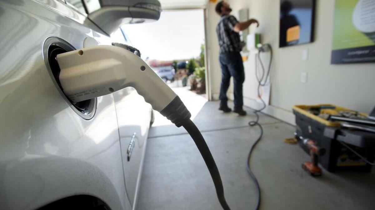 
An electric car recharges its batteries at KB Homes' Double Zero house 3.0 in El Dorado Hills on September 30, 2014. Senate Bill 350 envisioned a surge in electric cars by reducing petroleum-based auto fuel, but that provision was removed due to stiff opposition in the Assembly.
