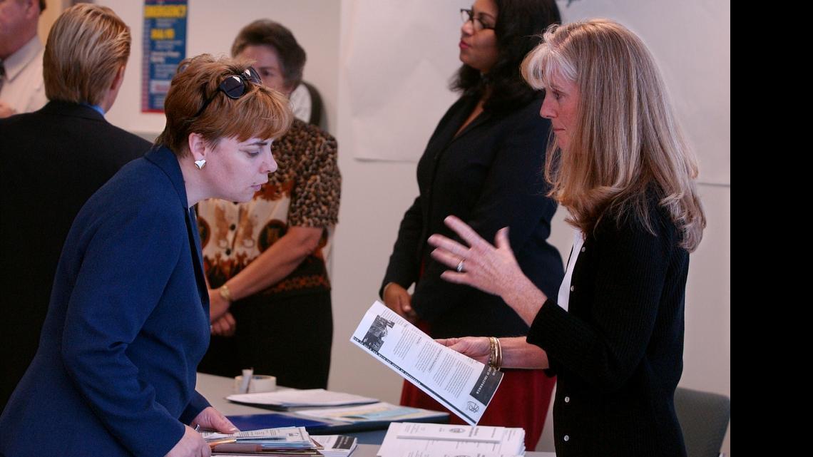 
A Department of Real Estate employee (right) talks to a job seeker during a job fair in Roseville.

