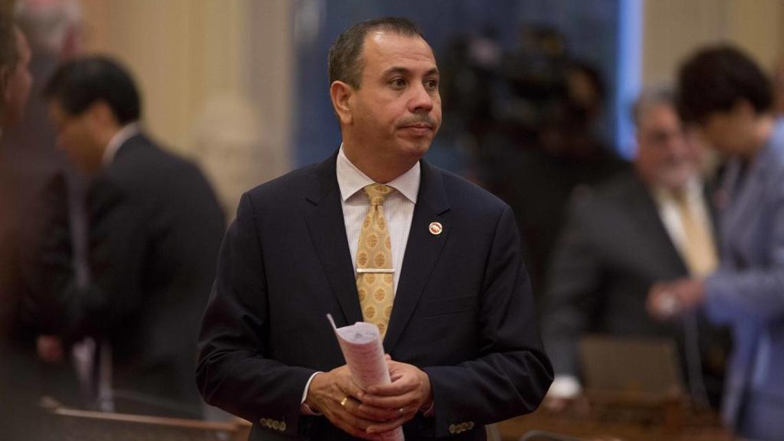Democratic State Sen. Tony Mendoza stands on the floor of the Senate chambers in between private meetings of the Democratic caucus, Wednesday, Jan. 3, 2018, in Sacramento, Calif. Mendoza stepped down temporarily as the Senate investigates sexual harassment allegations against him.