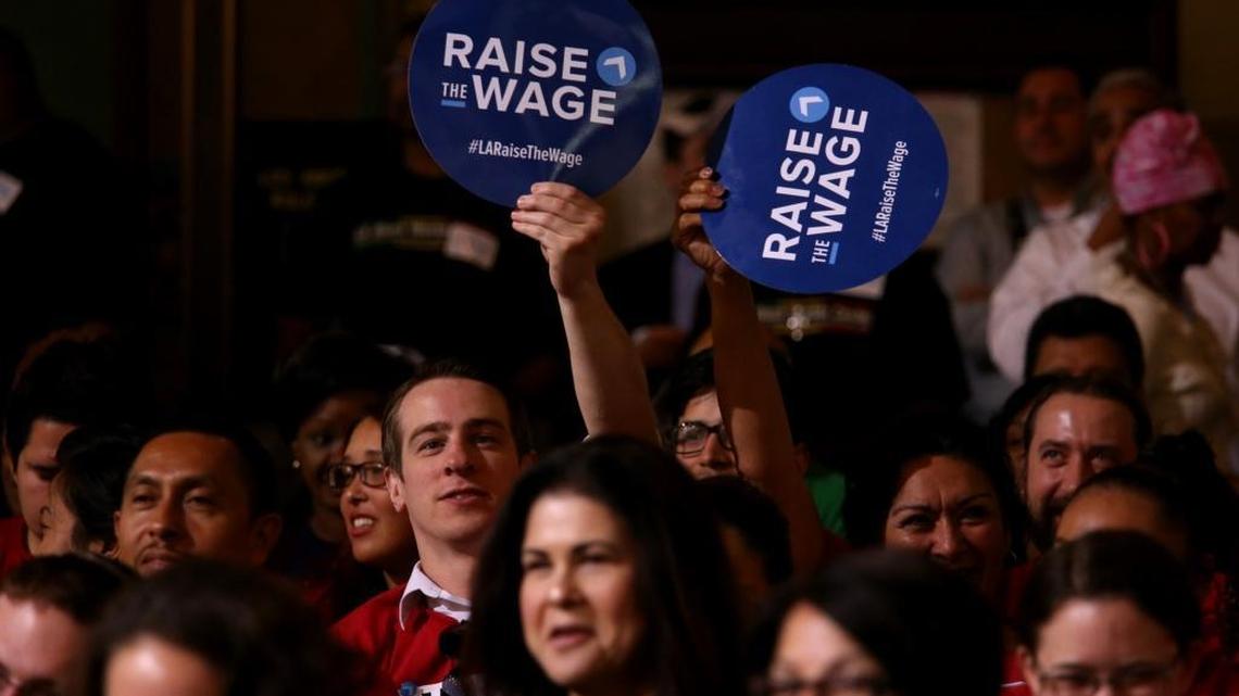 
Members of Unite Here show their support for raising the minimum wage before the Los Angeles City Council vote on May 19.
