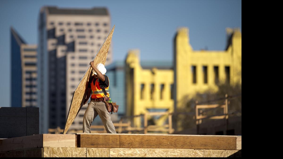 
Construction workers finish off the roof on the northwest corner of the Capitol Yards Apartments in West Sacramento in 2014. Construction is one of the most dangerous jobs and on-job injuries are covered by the workers’ compensation system.
