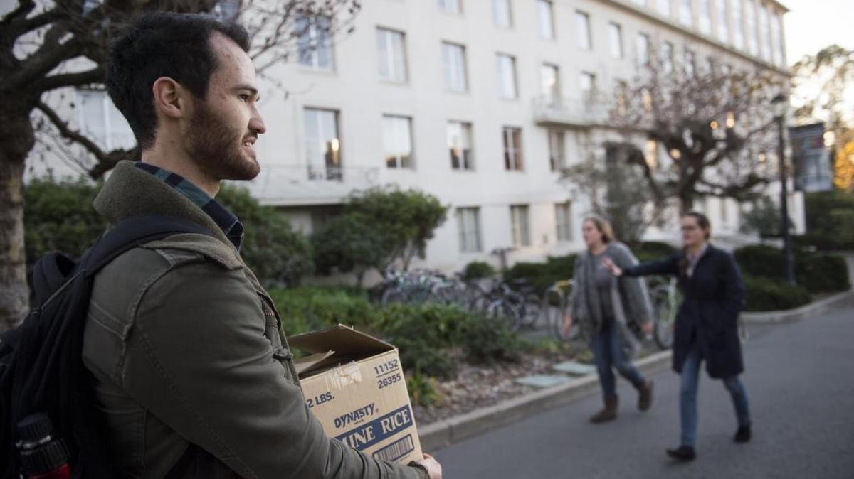 UC Berkeley student Ty Perez walks to class with a box of food from the Food Pantry on campus in December 2016. Perez found himself homeless during that fall semester when an apartment arrangement fell apart. He was able to find housing when he connected with the Homeless Student Union.