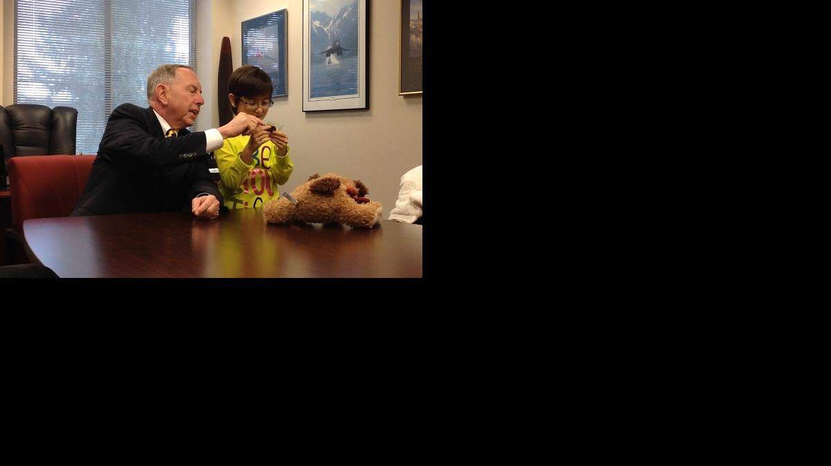 
Kimie Metcalf, the disabled 9-year-old who is lighting this year’s Capitol Christmas tree, receives a gift from state Sen. Richard Roth, D-Riverside, while visiting the Capitol on Tuesday.
