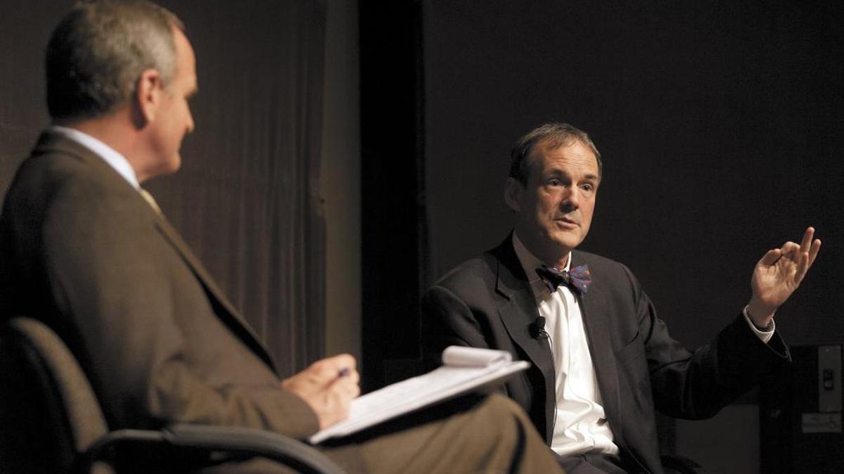 Charles Munger, Jr. speaks with GOP former state lawmaker Sam Blakeslee at a symposium at the Cal Poly Performing Arts Center Pavilion.