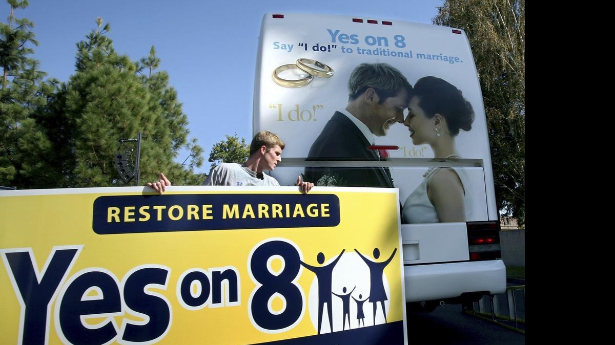 
Richie Beanan from Los Angeles, puts a sign on a bus that will tour California in support of Proposition 8. after a rally in Sacramento, Calif., on Monday, Oct. 20, 2008. If passed Proposition 8 would amend the California state constitution to ban same sex marriage. Proposition 8 would amend the California state constitution to ban same sex marriage. What public schools will be required to teach about same-sex marriage has emerged as the central issue in the Proposition 8 campaign. The measure's supporters warn that teachers will be forced to tell young young children about gay marriage if the measure fails on Nov. 4. Opponents of the measure call that a deceptive oversimplification, because the vote would not change what students already are being taught. (AP Photo/ Steve Yeater)
