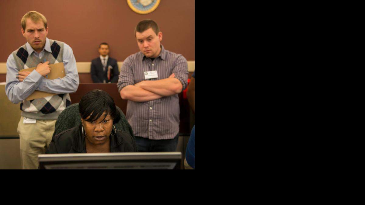 
Vote counting continues for the contest between Rep. Ami Bera and Doug Ose as election clerk Vickey Chatman verifies a provisional ballot and election observers from both campaigns look on Thursday in Sacramento.
