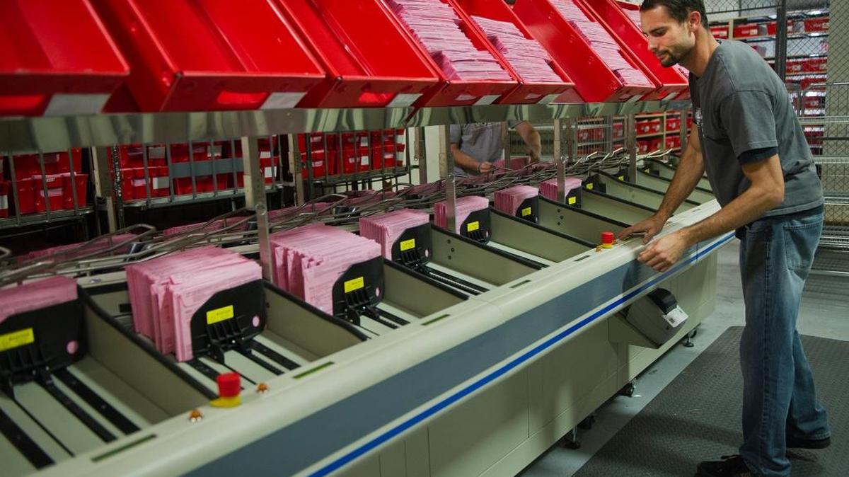 Election assistant Jason Parks prepares ballots to be extracted on Wednesday, November 7, 2012, in Sacramento, Calif.